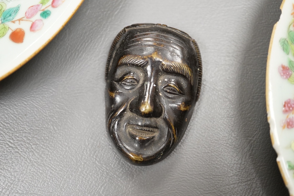 A Japanese bronze mask and four famille rose dishes - largest 29cm